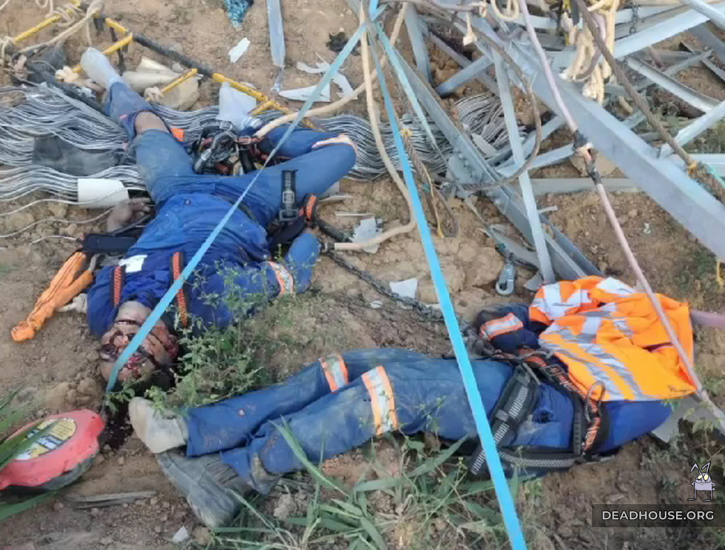 The corpse of a worker next to the debris of the power line mast