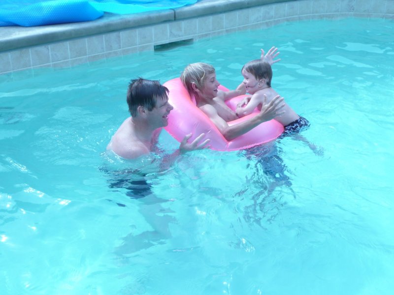 Denis with his family in the pool