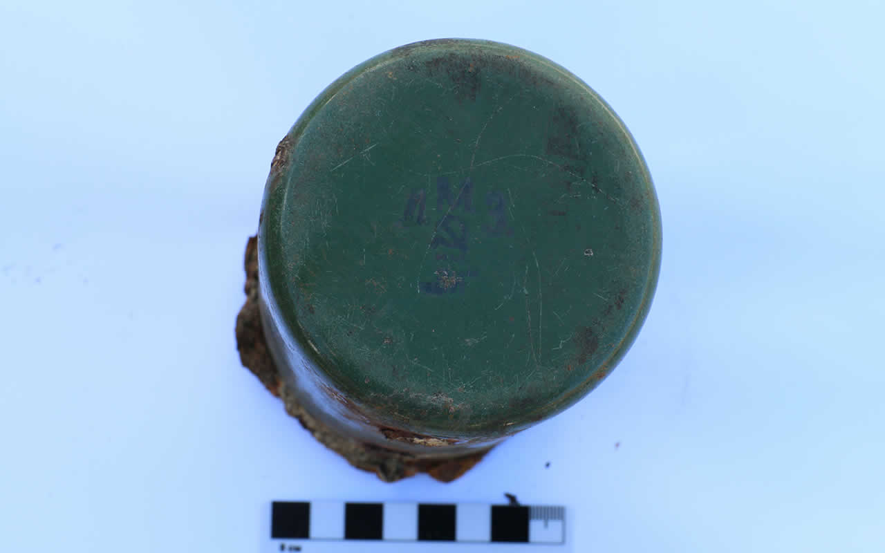Iron mug found among the remains of the victims