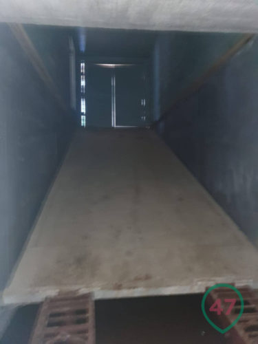 Sloping concrete sinking floor of an underground prison