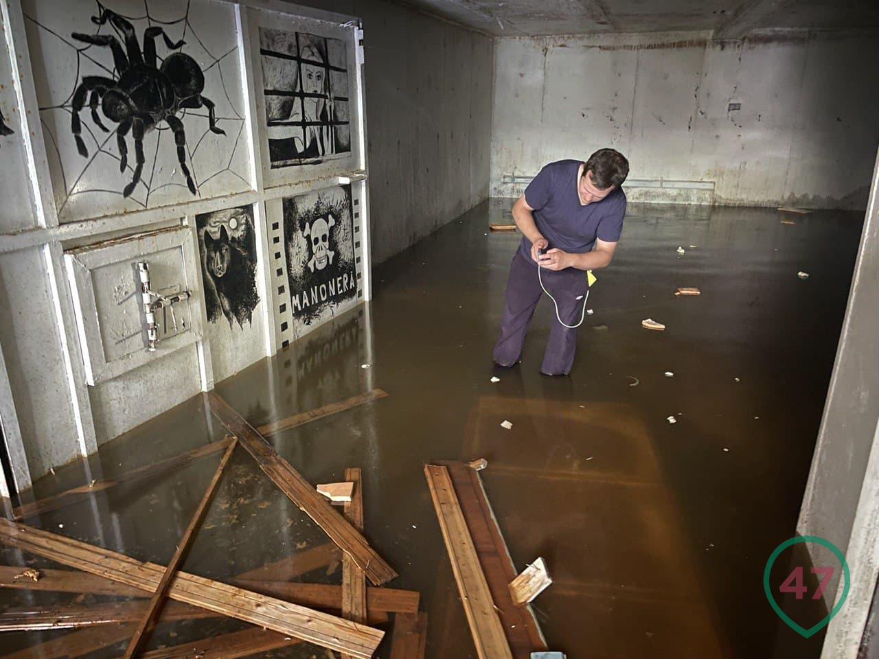 Flooded underground prison and graffiti gate