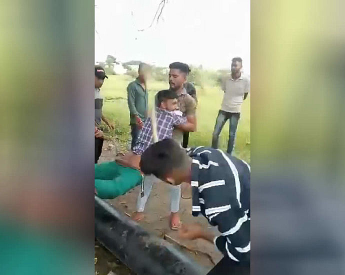 Hindu being beaten with a stick on his bare ass