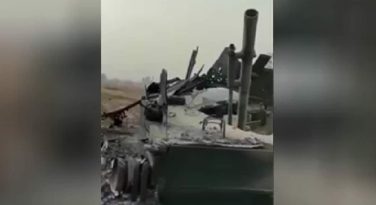 Corpses near a burned-out Russian infantry fighting vehicle