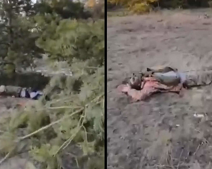 LPR fighter demonstrates the corpses of Ukrainian soldiers