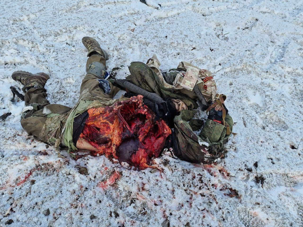 The corpse of a Russian soldier with a torn belly and chest