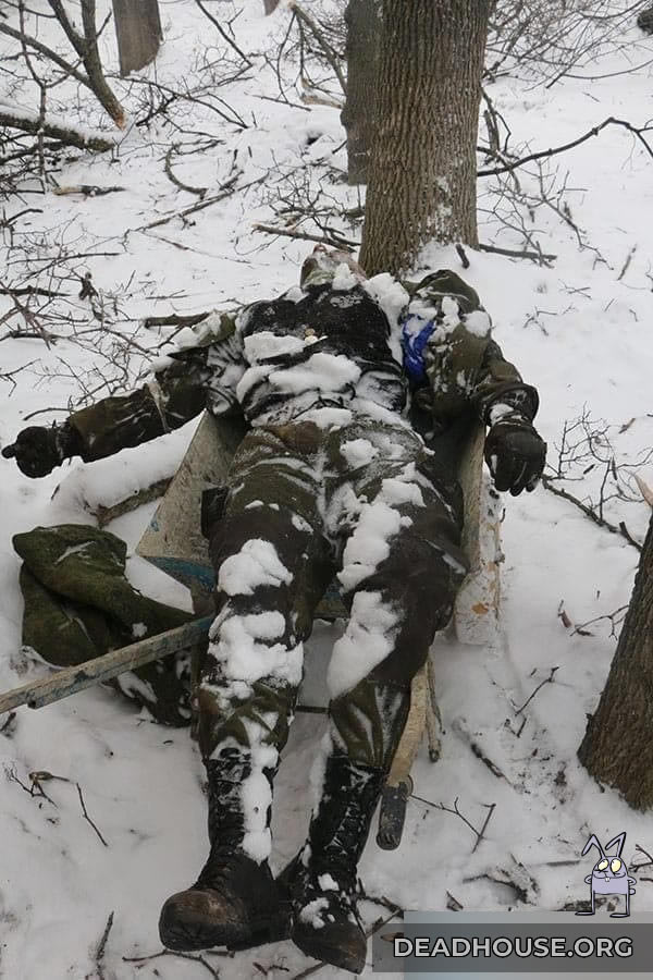 The corpse of a man in military uniform. Probably Russian military