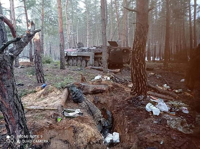 Abandoned MTLB in the forest and the corpse of a Russian soldier