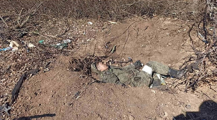 Dead Russian soldier in a trench