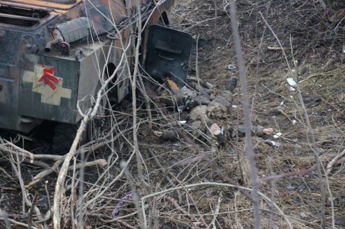 Padded Ukrainian BRDM and the corpse of a soldier