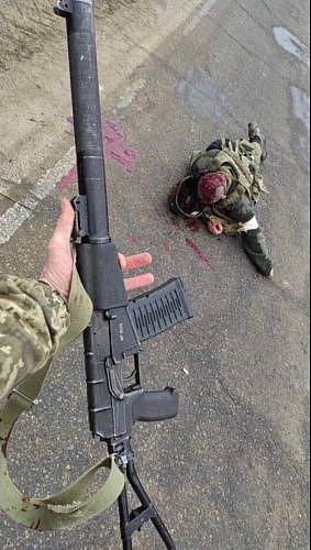 The corpse of a Russian military man and a captured VSS Vintorez rifle