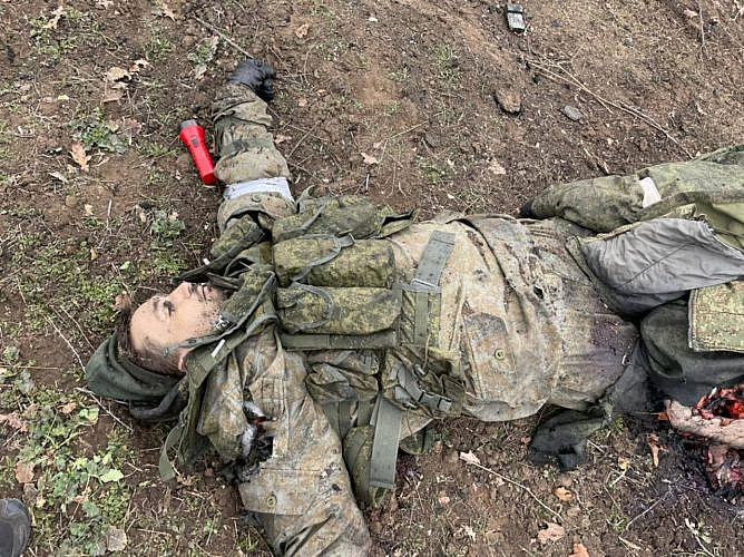 Corpse of Russian soldier with flashlight
