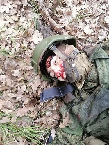 Corpse of Russian soldier in tactical helmet