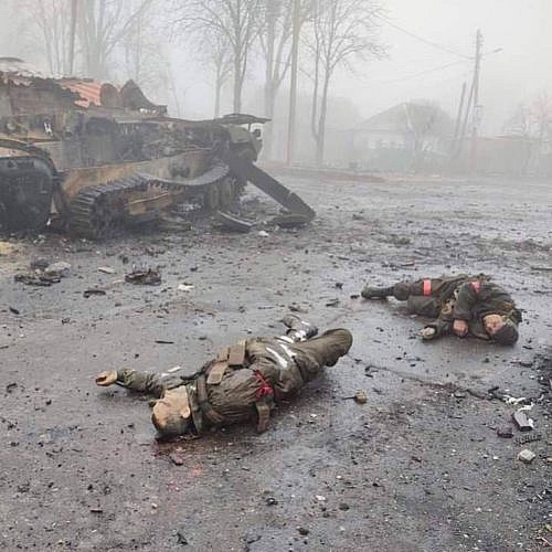 The corpses of the Russian military against the background of burned-out armored vehicles. Ukraine