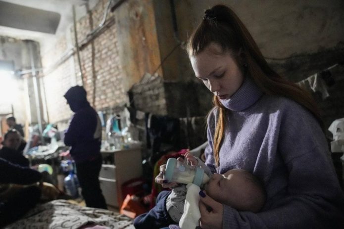The girl feeds the baby. Ukraine