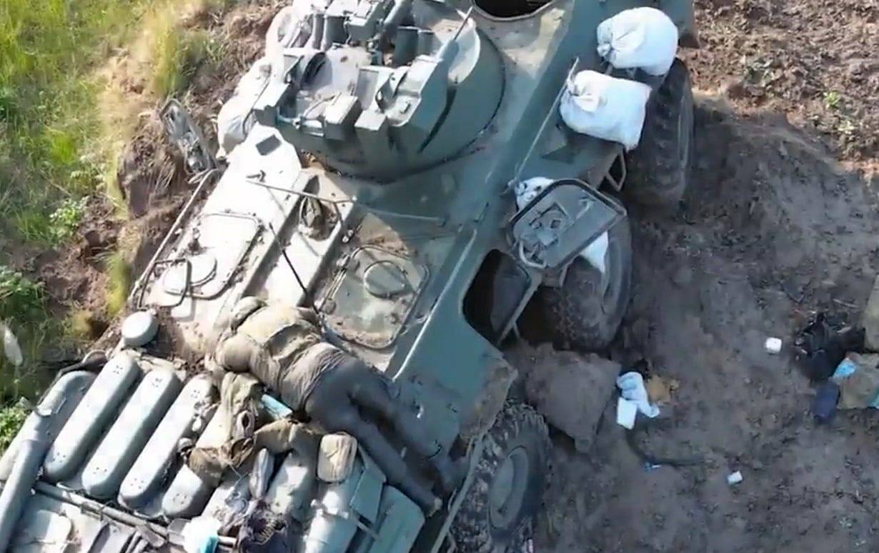 The corpse of a Russian soldier on a padded armored personnel carrier