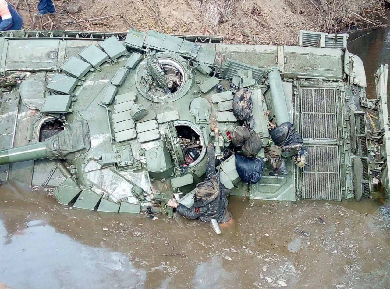 The corpses of Russian soldiers near a wrecked tank